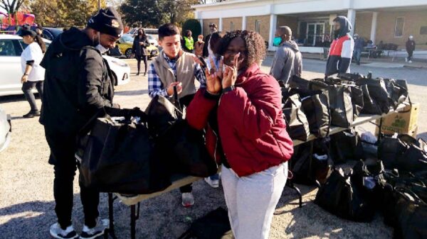 Volunteers sacking and giving away food bags at the Turkey Give Away