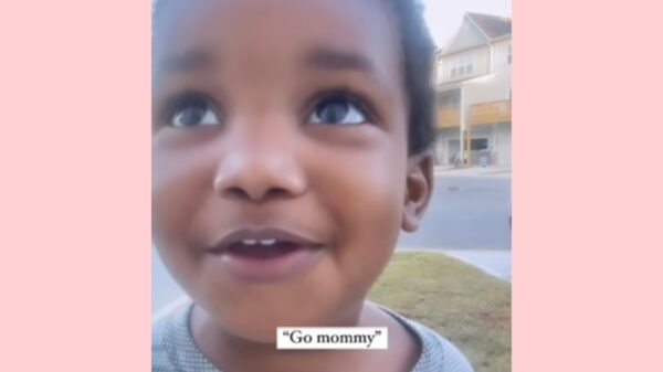 TODDLER CHEERING HIS MOTHER ON